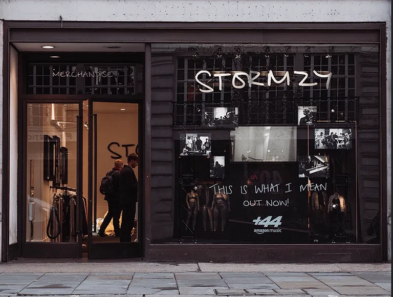 Shopfront window with Stormzy artwork on the glass and the words This Is What I Mean, out now